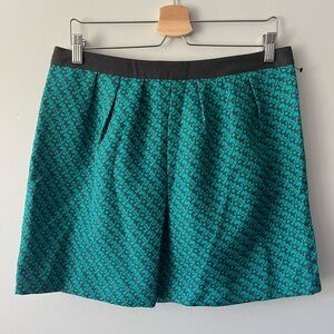 Structured mini skirt in teal and grey pattern.
